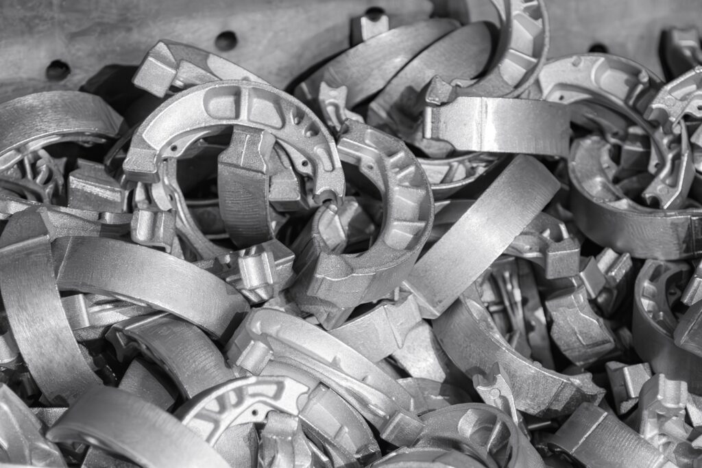 The pile of drum brake shoe from the aluminum die casting process. 