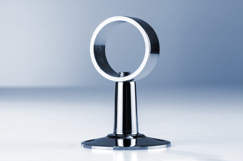 Nickel-plated CNC-machined metal support component with polished reflective finish.