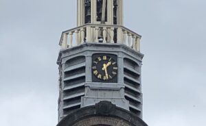 The Pilgrim Fathers Church near Rotterdam, featuring both a clock and a sundial—a historical tradition for accurate timekeeping.