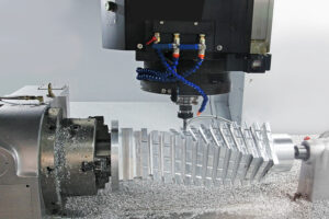 CNC machine milling a complex metal part with precise detailing and multiple cuts
