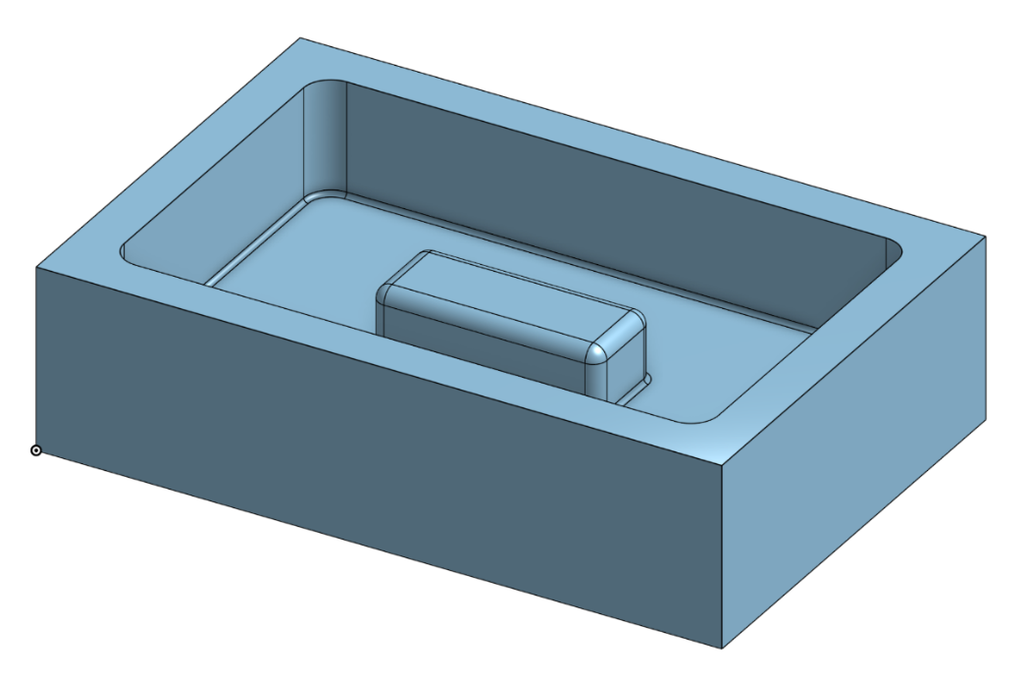 Pocket with a raised island feature left standing on the floor, machined into a block.